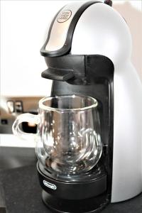 a coffee maker on a counter with a glass at The Lane - Boutique Residence in Galway