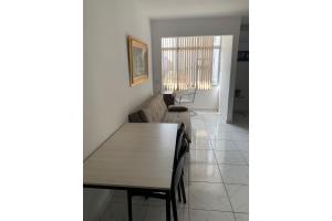 a dining room with a table and a couch at Loft Central Master Collection in Passo Fundo