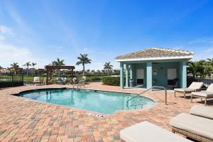 a swimming pool with a patio and a house at Fortebello Beachside - 164 in Indian Harbour Beach