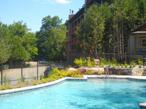 a swimming pool in front of a building at Bernache in Mont-Tremblant