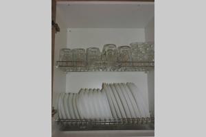 a shelf with a row of glasses in a refrigerator at Buhardilla rústica muy acogedora in Villahermosa del Río +25 photos