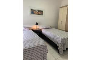 two beds sitting next to each other in a room at Loft Central Master Collection in Passo Fundo +12 photos