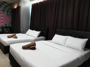 Ghazrins Hotel Dataran Larkin tesisinde bir odada yatak veya yataklar