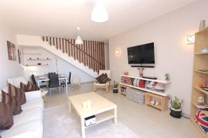 a living room with a white couch and a table at Villa Emma Playa Blanca in Playa Blanca