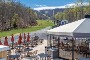 a group of tables and chairs with a white tent at Mountainside Villas at Massanutten by TripForth in McGaheysville