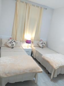 Postel nebo postele na pokoji v ubytování CASA PARAISO