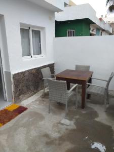 un patio con mesa y sillas y un edificio en CASA PARAISO, en Corralejo