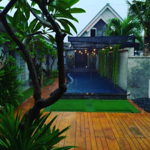 a swimming pool in the backyard of a house at Surfer Garden in Sanur