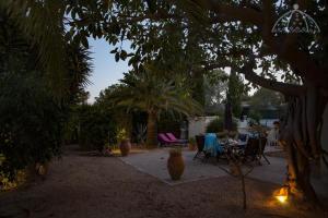 a patio with a table and chairs under a tree at Villa Los Pinos 6 in Altea