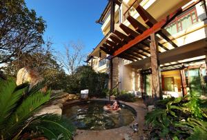 a woman swimming in a pool in a backyard at HUALUXE Hotels & Resorts Kunming, an IHG Hotel in Kunming