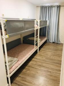 two bunk beds in a room with a wooden floor at Majestic Hostel Porto in Porto