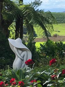 
a statue of a woman in a flower arrangement at Windrush BnB - Comboyne Australia in Comboyne
