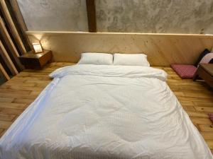 Voodi või voodid majutusasutuse Yilan For A Night B&B toas