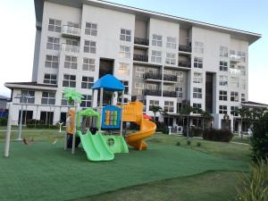 a playground in front of a apartment building at Playa Caracol Beachfront Residence Club in Chame
