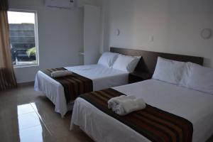 En eller flere senge i et værelse på Mare S&M Casa Hostal