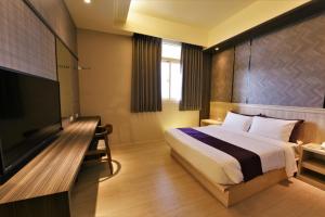 Postel nebo postele na pokoji v ubytování Yu Kun Tien Hotel