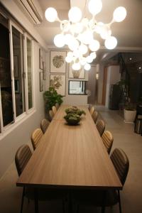 墾丁後灣 藍水軒海景民宿 في تشيتشينج: غرفة طعام مع طاولة وكراسي خشبية