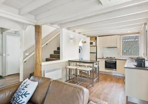a living room with a couch and a kitchen at Diamantina in Dinner Plain