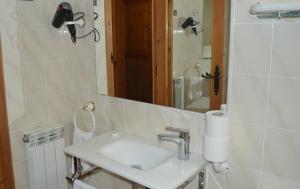 a bathroom with a sink and a mirror at Pensión Panticosa in Panticosa