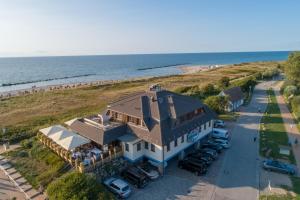 an aerial view of a house with the beach at Moby Dick Hotel & Ferienwohnungen in Wustrow