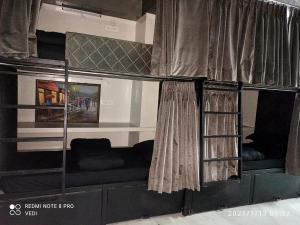 a bunk bed in a room with a window at Dormitory in Udaipur