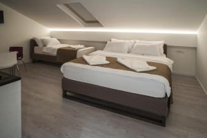 a hotel room with two beds and a bedvisor at Apartments Villa Savamala in Belgrade