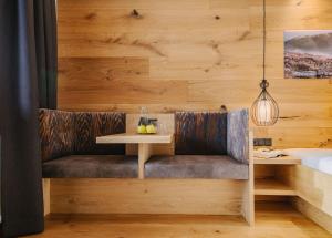 a dining bench with a table in a room with wooden walls at loisi's Boutiquehotel in Achenkirch
