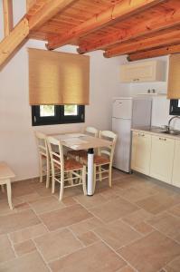 a kitchen with a table and chairs in a room at Kleopatra Villas - Seaside Suites in Kolios