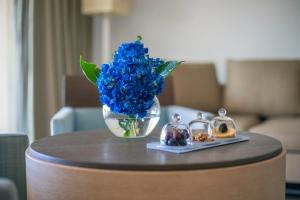 a vase of blue flowers sitting on a table at Capovaticano Resort Thalasso Spa in Capo Vaticano