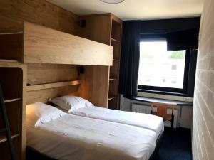 Voodi või voodid majutusasutuse Vakantiedomein Hoge Duin toas
