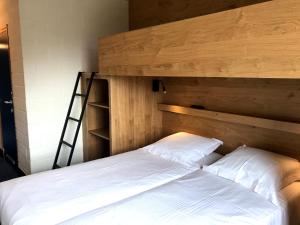 Voodi või voodid majutusasutuse Vakantiedomein Hoge Duin toas