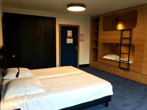 a bedroom with a large bed and a book shelf at Vakantiedomein Hoge Duin in Oostduinkerke