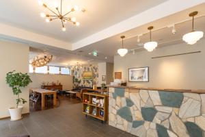 a lobby of a salon with a stone counter at The OneFive Tokyo Shibuya in Tokyo