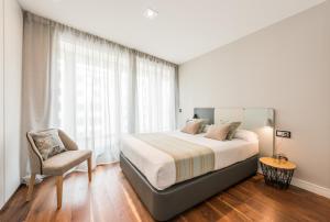 Łóżko lub łóżka w pokoju w obiekcie Gran View Apartments