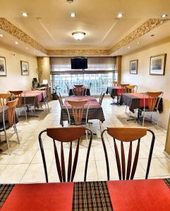 a restaurant with tables and chairs and a flat screen tv at Noufara in Piraeus