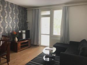 a living room with a couch and a tv at Vaasa Apartments 4 in Vaasa