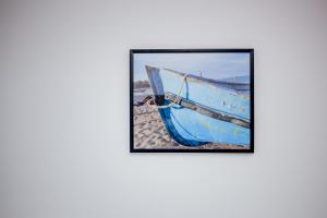 a blue boat sitting on top of a beach at Happy In Vama Veche in Vama Veche