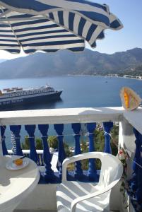 a balcony with a cruise ship in the water at Annas Studios in Livadia