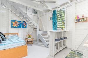 a room with a bed and a staircase in it at Appartement charmant au Carbet avec vue sur la mer - 50 m² in Le Carbet