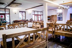 a dining room with wooden tables and chairs at Dwa Dęby in Lubawka