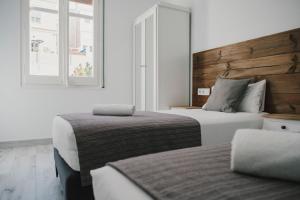 a bedroom with two beds and a window at BBarcelona Fira Superior Flats in Barcelona
