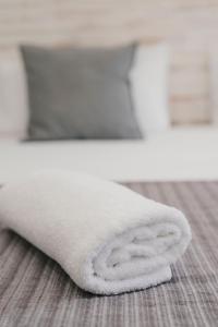 a white towel sitting on the floor in a bathroom at BBarcelona Fira Superior Flats in Barcelona