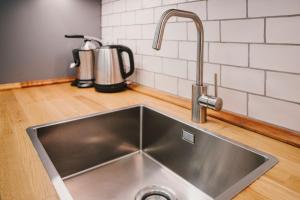 a kitchen sink with a faucet on a counter at BBarcelona Fira Superior Flats in Barcelona