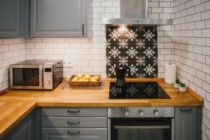 a kitchen with a counter top with a microwave at BBarcelona Fira Superior Flats in Barcelona