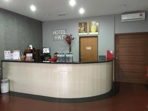 a hotel lobby with a reception counter and a person at HKF Hotel in Kajang