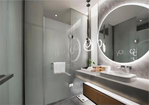 a bathroom with a sink and a mirror at EVEN Hotel Nanjing Yangtze River, an IHG Hotel in Nanjing