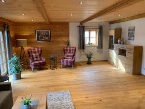 a living room with two chairs and a table at Webergütl - Chiemgau Karte in Inzell