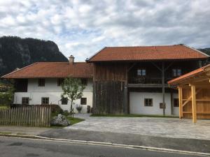 a large white house with a brown roof at Webergütl - Chiemgau Karte in Inzell