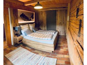 a bedroom with a bed in a wooden room at Webergütl - Chiemgau Karte in Inzell