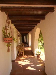 an external view of a porch with a wooden ceiling at Hotel Villa Mediterranea in Noto Marina